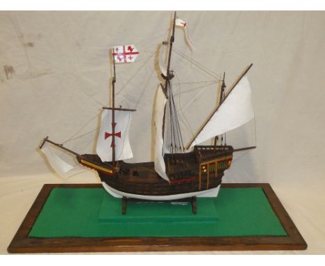 A wooden scale-built model of a three-masted galleon contained within a glazed rectangular display case, 26" wide x 27" high