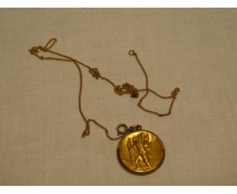 A 9ct gold mounted circular St Christopher pendant with chain