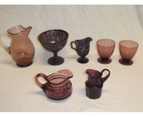 A selection of amethyst tinted glass including Victorian slag glass pedestal bowl and similar pedestal jug; Victorian pressed