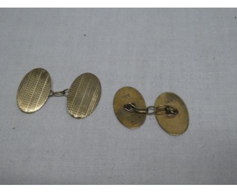 A pair of gentleman's 9ct gold oval cufflinks with engine turned decoration