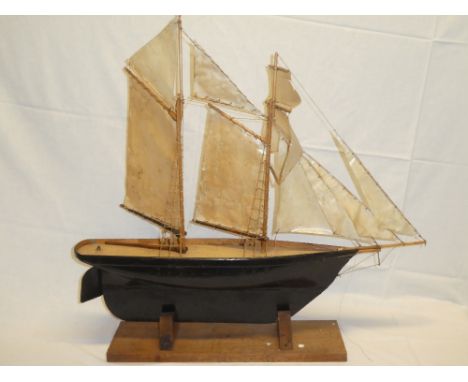 An old wooden scale built model of a two-masted schooner 30" long on wooden stand