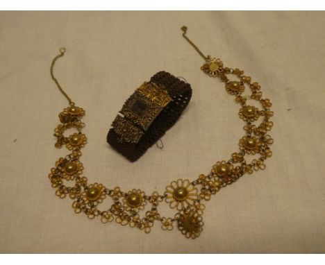 A Victorian pinchbeck mounted memoriam bracelet with inset hair panel and woven strap together with a gilt floral decorated n
