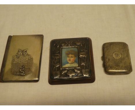 A miniature portrait in silvered rectangular frame, small silver concave rectangular cigarette case and a Continental wallet 