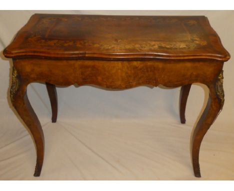 An ornate 19th century French inlaid walnut turn-over top card table with baize lined playing surface, floral inlaid top on s