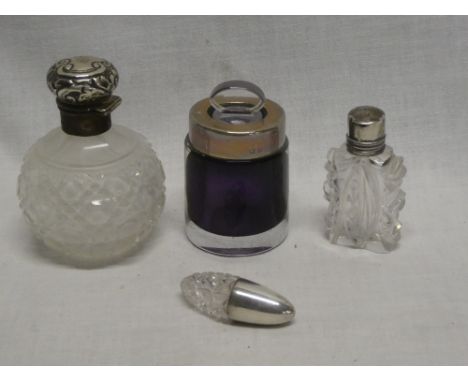 A cut-glass scent bottle with silver mounted top, Birmingham marks; amethyst tinted glass scent bottle with silver mounted ri