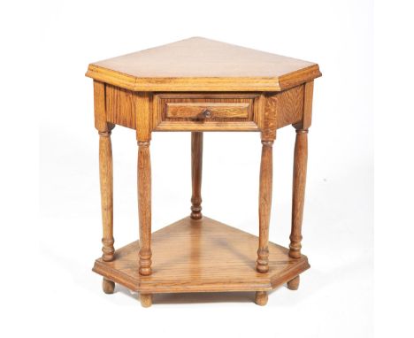 A 20th Century oak corner table
With a single frieze drawer, button handle raised on ring turned tapering supports above an u