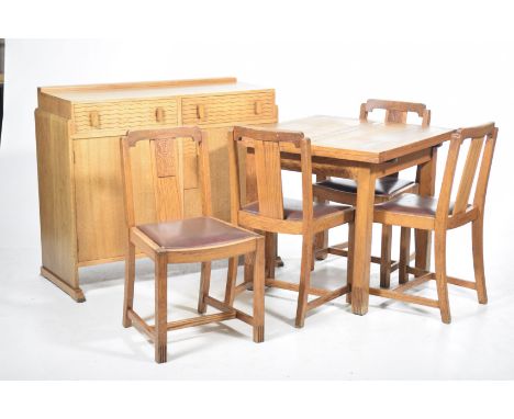 A Mid 20th Century light oak dining room suite
The sideboard with two frieze drawers each incised with wavy lines above two c