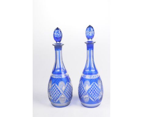A pair of early 20th Century Bohemian blue overlay glass decantersEach of pear form rising to a flared rim, surmounted by fac