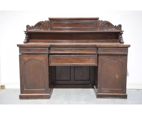 A mid 19th Century mahogany sideboard
The raised back with a single shelf supported on C scroll supports above a rectangular 