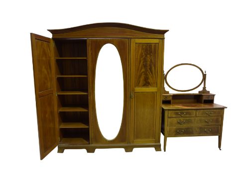 An Edwardian inlaid mahogany wardrobe and conforming dressing tableThe wardrobe with an arched moulded pediment above a centr