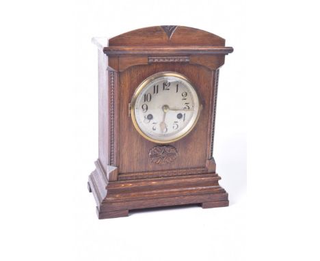 An oak cased mantle clock, circa 1910
The silvered dial with Roman numerals, the movement stamped D.R.G.M, height approximate