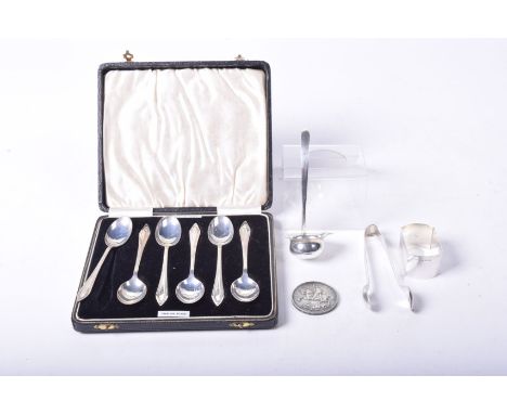 A set of six silver teaspoons Cased, Birmingham 1939, together with, a silver ladle, a silver napkin ring, a pair of silver s