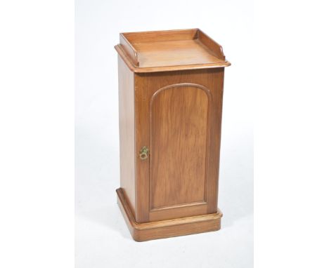 A Victorian pine pot cupboardWith a galleried top above a single panelled cupboard door enclosing a single shelf raised on a 