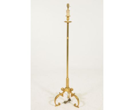 A gilt metal standard lamp The three 'S' scroll base, rising to a reeded central shaft, and terminating at a faux candle and 
