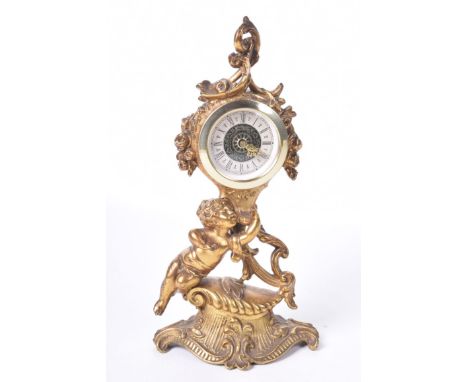 A gilt metal mantel clock in the Louis XVIII style, late 20th CenturyThe white face with Roman numerals and Precista label ma