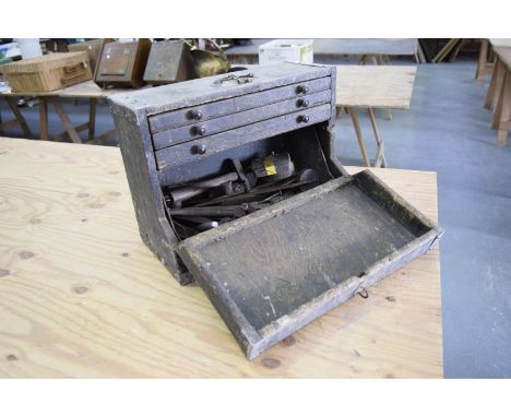 A Victorian pine tool chest and a collection of tools
The chest with a swing handle above a fall front enclosing three fitted