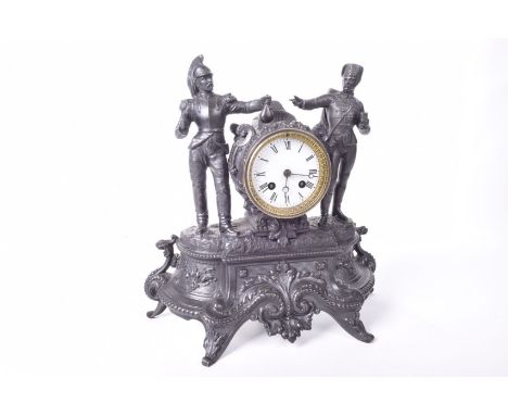 A spelter French mantel clock  late 19th Century The eight day clock with 8cm diameter white enamel dial with Roman numerals,