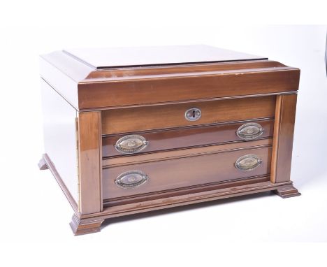 A 20th Century walnut cutlery canteenThe hinged caddy top enclosing a compartmentalized interior stamped "Carrs Sheffield, En