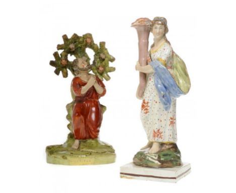 A STAFFORDSHIRE PEARLWARE FIGURE OF CERES WITH OVERGLAZE ENAMEL DECORATION AND A CONTEMPORARY STAFFORDSHIRE FIGURE OF ST PETE