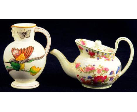 A WEDGWOOD EARTHENWARE GROUPS PATTERN CAPE TEAPOT AND COVER AND A WEDGWOOD EARTHENWARE DORIC JUG, DECORATED WITH HUMMING BIRD