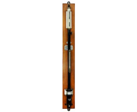 A BRASS AND BLACK JAPANNED METAL FORTIN BAROMETER BY F DARTON & CO LTD SUSPENDED BEFORE VARNISHED MAHOGANY WALL PLATE