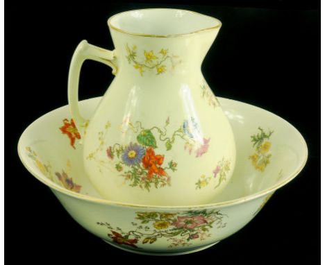 A LIMOGES PRIMROSE GROUND CHAMBER JUG AND BASIN DECORATED WITH FLOWERS AND GILT, CIRCA 1900