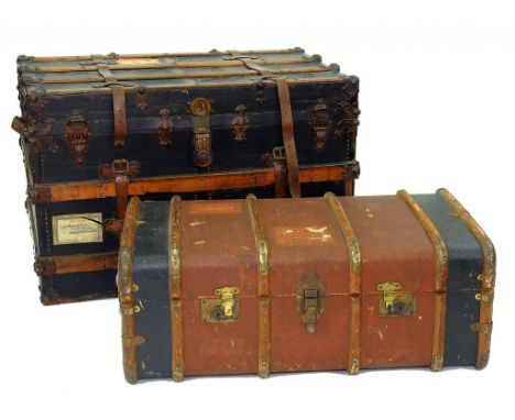 AN EARLY 20TH CENTURY BLACK CANVAS COVERED CABIN TRUNK WITH IRON MOUNTS AND WOOD SLATS AND ANOTHER, SMALLER