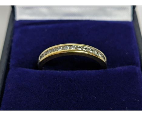 AN 18CT GOLD DIAMOND SET HALF ETERNITY RING, set with  thirteen channel set brilliant cut diamonds, approximate diamond weigh