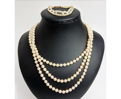 A THREE STRAND CULTURED PEARL NECKLACE, the pearls of 7mm diam approx, 9ct gold clasp, 46cm L, plus a pearl bracelet. (2) 