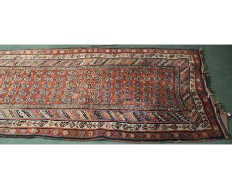 Middle Eastern runner, the red ground with lozenge pattern centre and multiple borders, 370cm x 125cm