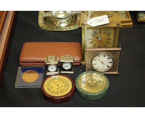 Forty-year paperweight calendar, world time zone paperweight, two miniature plated clocks, a brass carriage clock, cased ther