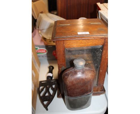 Oak smokers cabinet, together with a large pewter and glass flask and an iron stand (3)