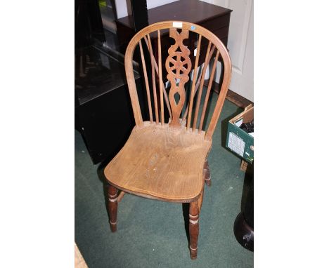 Set of four elm seated stick and wheelback kitchen chairs. each with turned legs united by stretchers, each approx. 90cm high