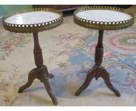 A pair of lamp tables, having brass gallery, inset marble top on tripod base.