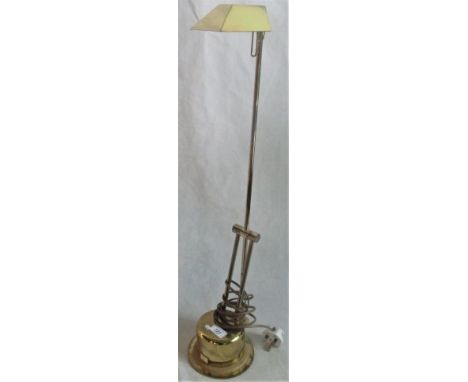 A contemporary brass angle-poise table lamp.