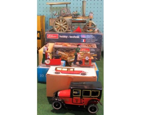 A Wilesco steamroller traction engine, together with a water cart of the same name and other related toys.