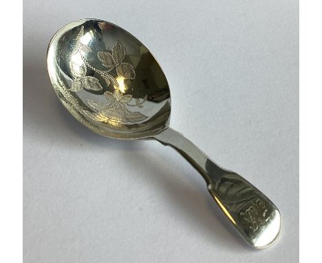 A silver fiddle pattern caddy spoon with floral decoration. London. By JB. Approx. 13 grams.
