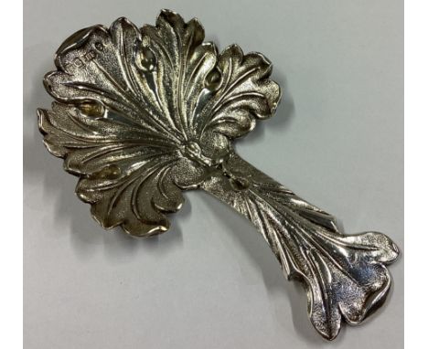 A good cast silver caddy spoon with scroll decoration. Birmingham 1827. By JD. Approx. 13 grams. 