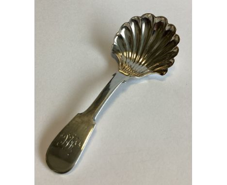 NEWCASTLE: A Georgian silver fiddle pattern caddy spoon with fluted bowl. By TW. Approx. 12 grams.