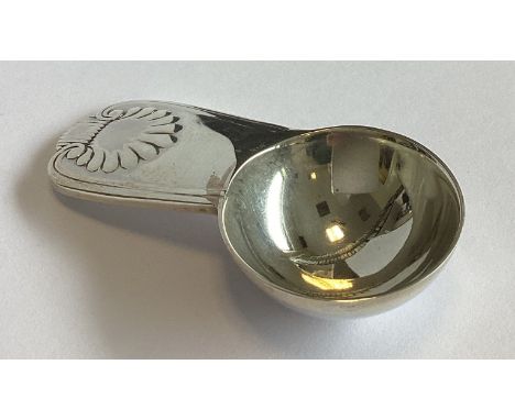 A small heavy cast silver caddy spoon with shell thumbpiece. London 2006. By VD. Approx. 36 grams.