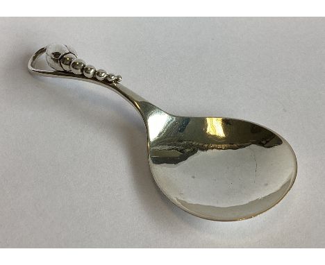 GEORG JENSEN: A good heavy silver caddy spoon of stylised form. Marked verso '84'. Approx. 18 grams.