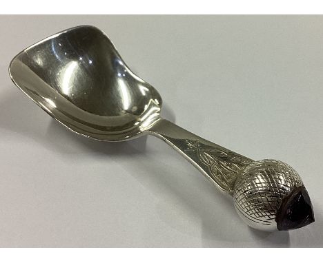 An unusual engraved silver caddy spoon with faceted amethyst to terminal. Birmingham. By JC&S. Approx. 24 grams.