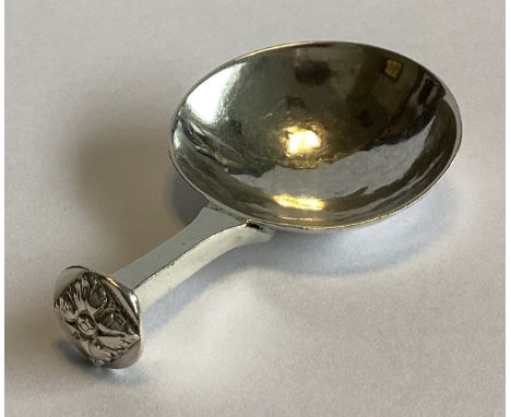 A E JONES: A stylish silver caddy spoon with small tapering handle. Birmingham 1919. Approx. 18 grams.