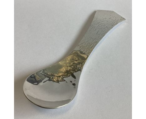 A large silver caddy spoon of textured form. London 1984. By GW. Approx. 41 grams.