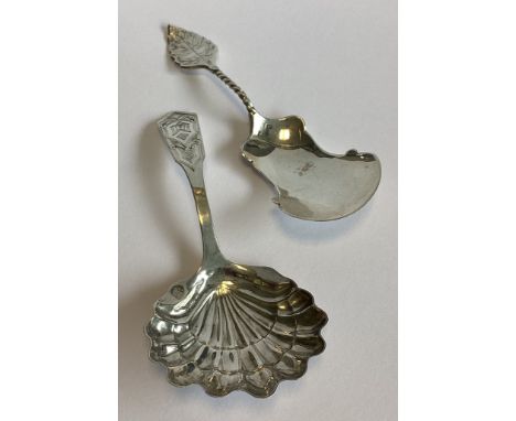Two large Continental silver caddy spoons with leaf decoration. Approx. 21 grams.