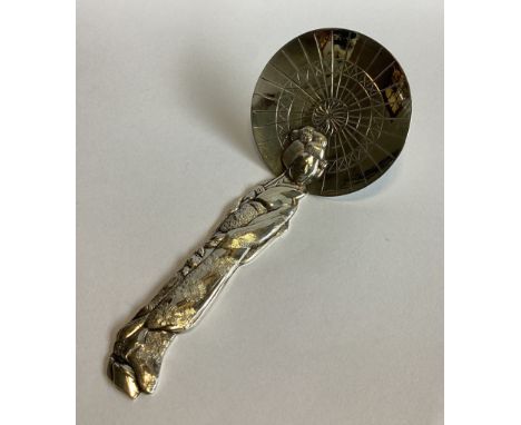 An unusual Japanese silver caddy spoon in the form of a lady beneath umbrella. Approx. 26 grams. 