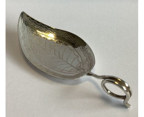 A stylish silver leaf-shaped caddy spoon with bright-cut decoration. Birmingham 1852. Approx. 10 grams.