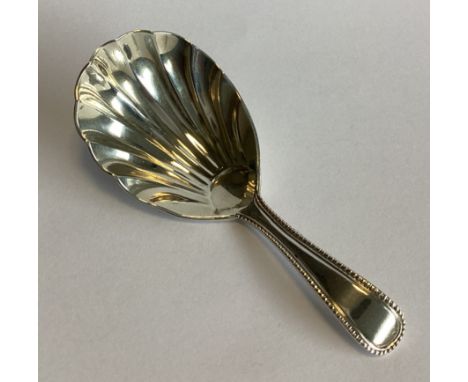 A Victorian silver bead edge caddy spoon. London 1864. By GA. Approx. 15 grams.