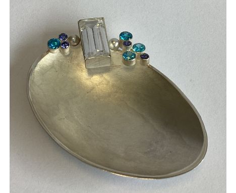 A contemporary shaped silver caddy spoon of textured form with stone set handle. Numbered 5/20. London 2017. By Loucinda Nims