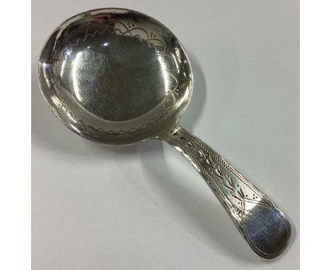 A Georgian silver caddy spoon with bright-cut decoration. Birmingham 1821. By IT. Approx. 8 grams.